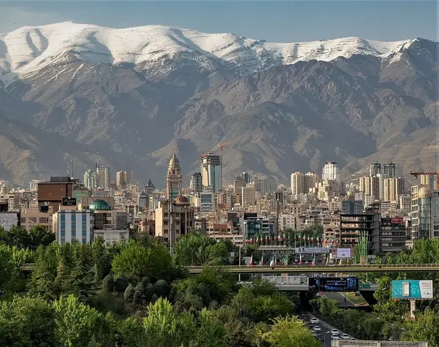 Tehran skyline with the Alborz mountains rising above modern high-rises